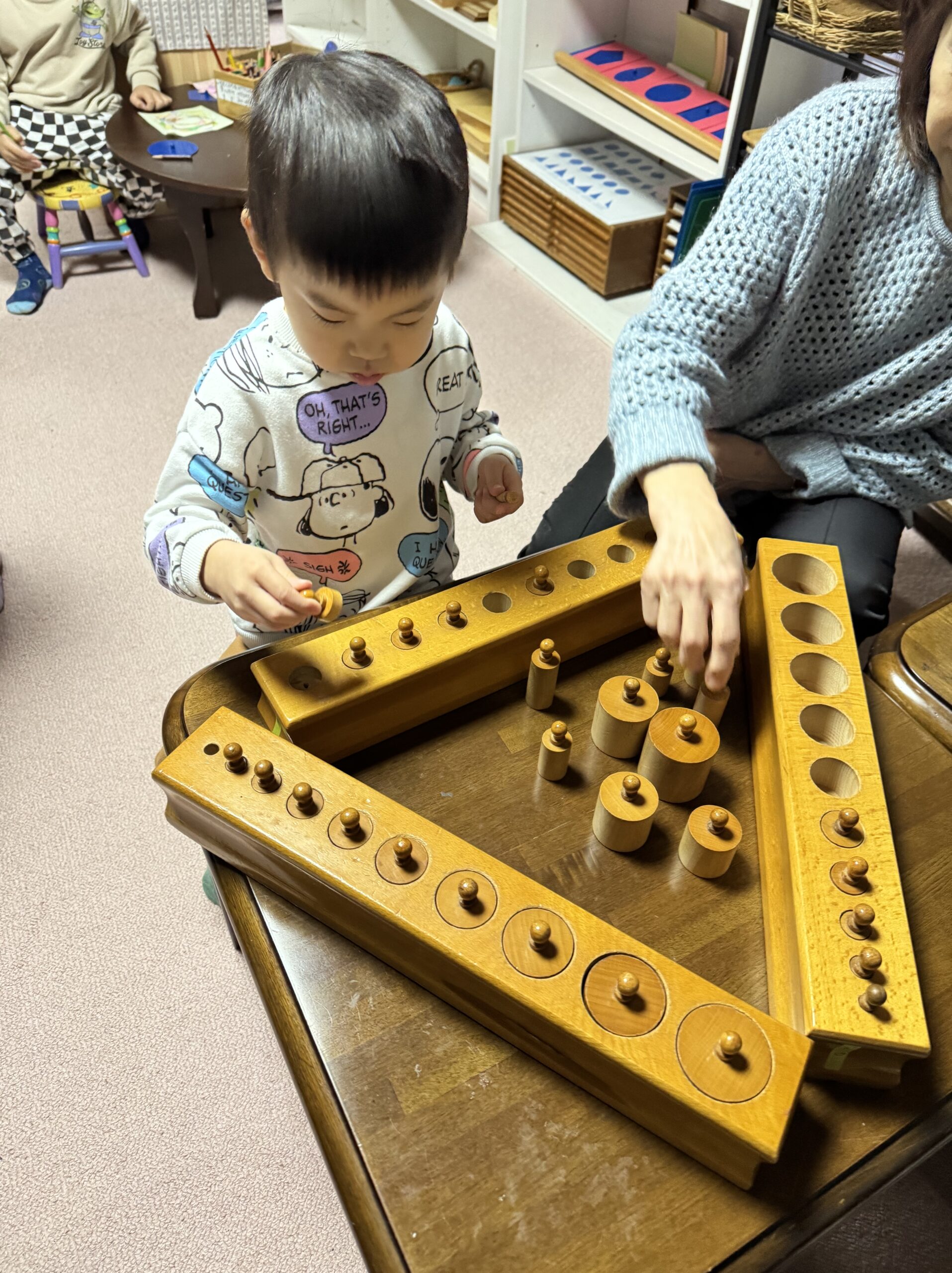 教室で教具に取り組むこども